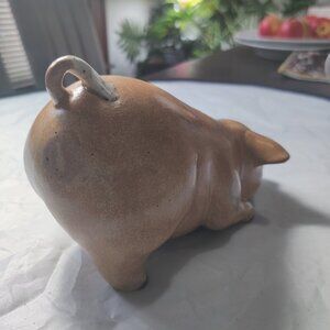 A pig figurine, wallowing in mud. Handpainted and very Realistic with mud spots